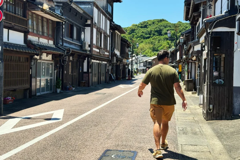 walking the streets of hirado with typical japanese buildings on the side of the road