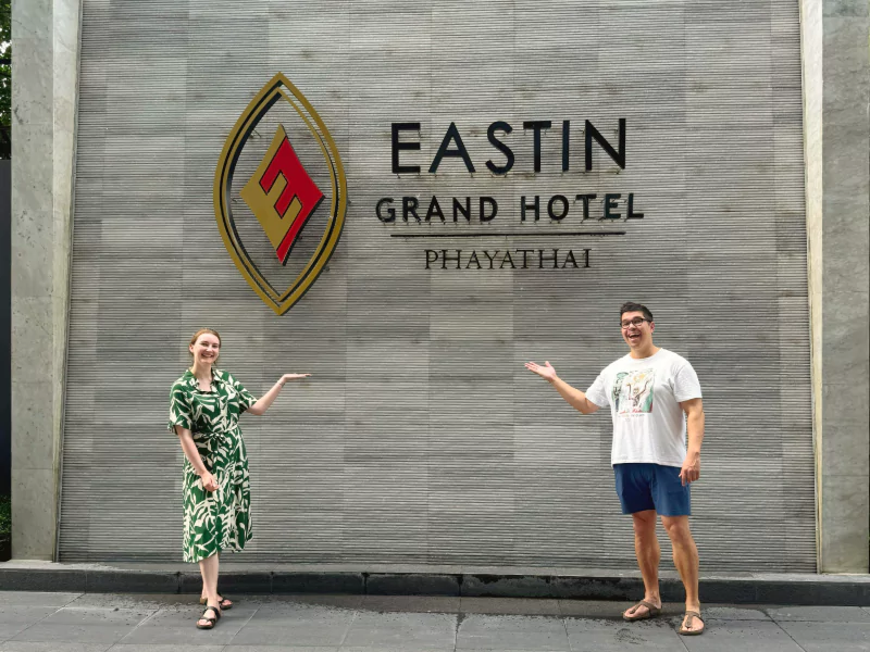 laurens and laura in front of eastin grand hotel phayathai sign