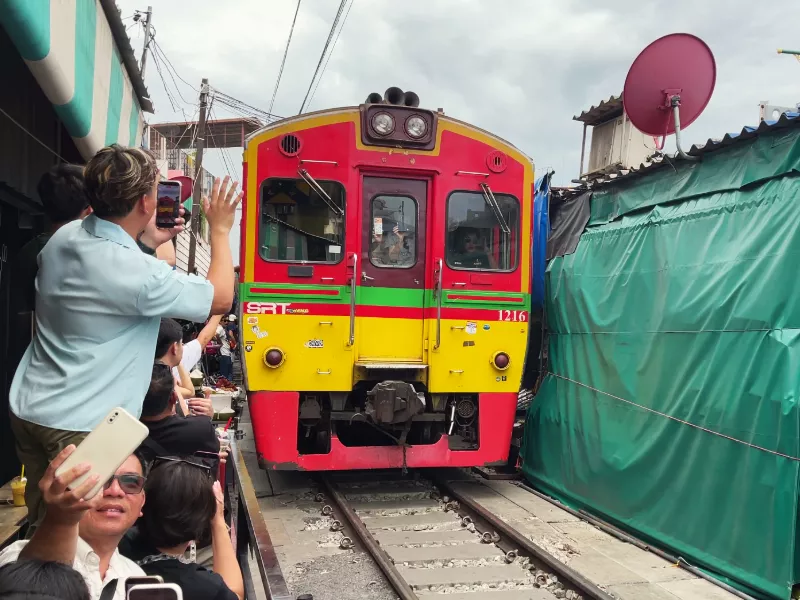 maeklong railway market train passing